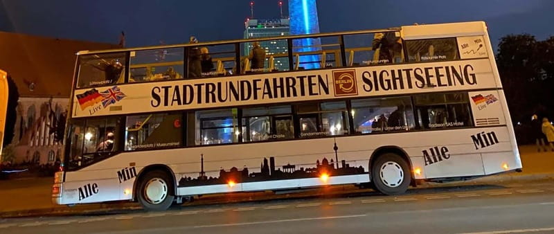 Berlin: Bus Tour by Night with Live Commentary - Alexanderplatz: Red Town Hall and the World Clock in projection light