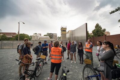 Berlin Wall and Cold War Bike Tour in Small Groups - Stop 1: Brandenburg Gate makes the Cold War feel real